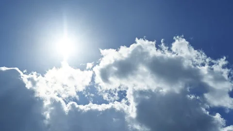Sun, blue sky, white clouds, cottony cumulus, sunbeams - timelapse Stock Footage 318111576