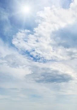 Sun on blue sky with white clouds Stock Photos
