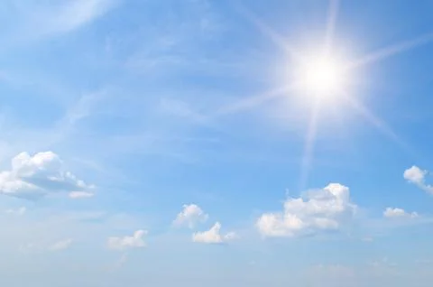 Sun on blue sky with white clouds Stock Photos