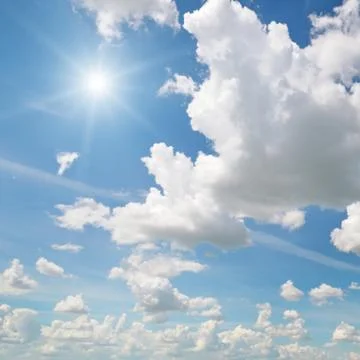 Sun on blue sky with white clouds Stock Photos