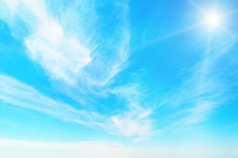 Sun on blue sky with white clouds Stock Photos