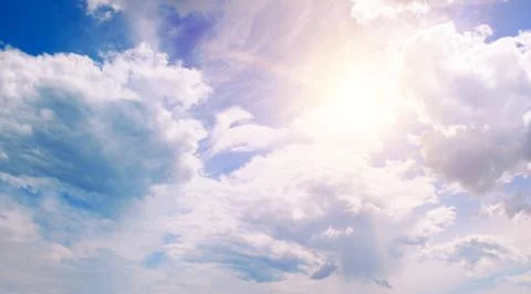 Sun on blue sky with white clouds 스톡 사진
