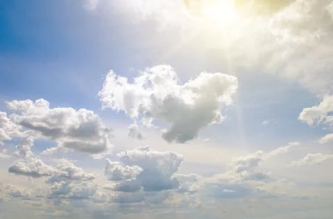 Sun on blue sky with white clouds. 스톡 사진