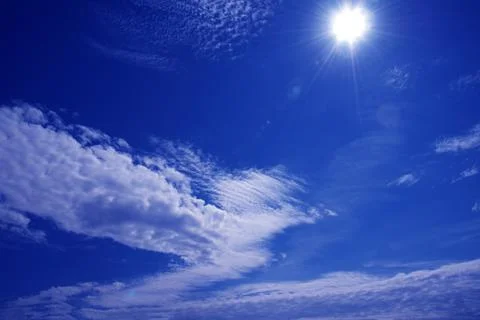 Sun on a blue sky with  a white clouds, nature background Stock Photos