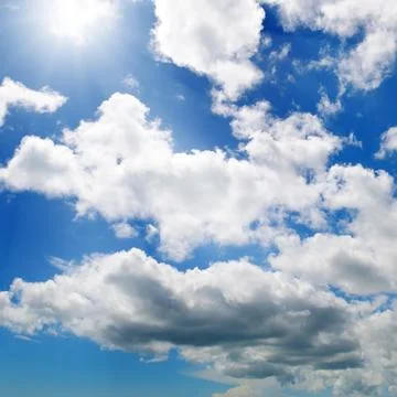 Sun on blue sky with white clouds. Stock Photos