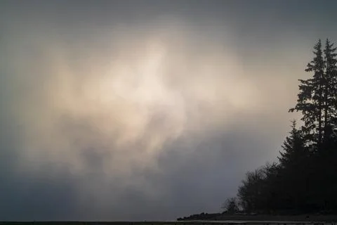 Sun Break - Early moring light tries to break through the fog at Bottle Beach Stock-Fotos