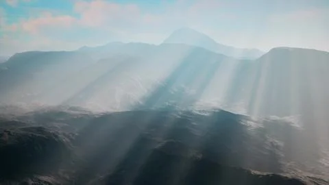 Sun breaking through clouds over majestic mountains Stock Illustration