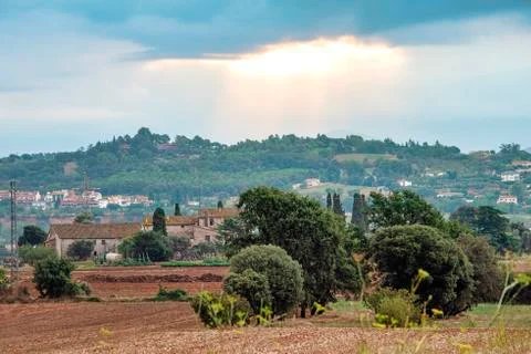 Sun breaking through the clouds over the fields and mountains of rural Spain Stock Photos