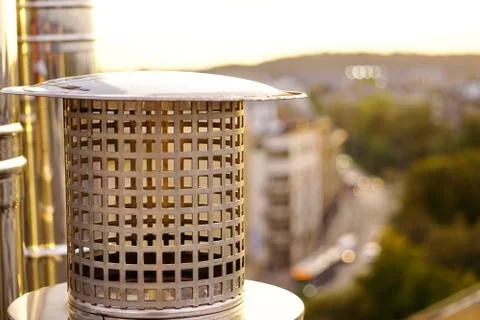 The sun breaking through the clouds, the ventilation pipes on the roof. refle Stock Photos