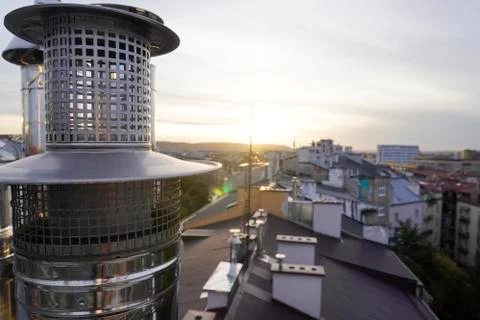 The sun breaking through the clouds, the ventilation pipes on the roof. refle Stock Photos