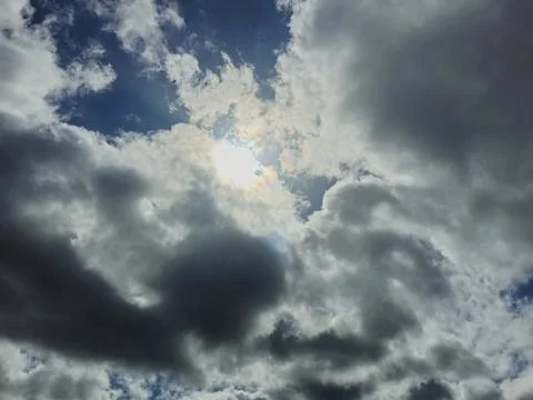 Sun Breaking Through Dark Storm Clouds in Moody Sky Stock Photos