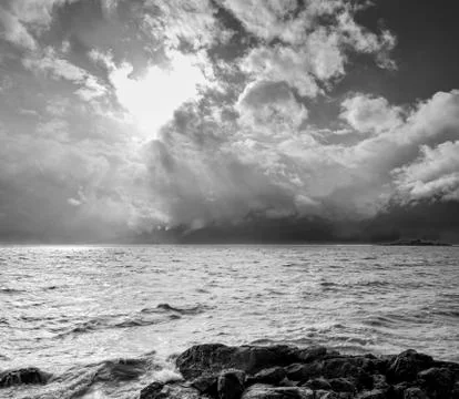 Sun breaking through storm clouds on the Alaska coast Stock Photos
