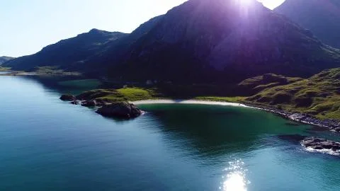 The sun is breaking through the top of a mountain in Norway Stock Photos