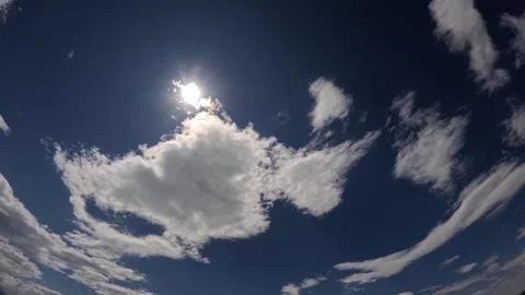 Sun Breaking Through White Clouds in Deep Blue Sky Time Lapse 動画素材 337723577
