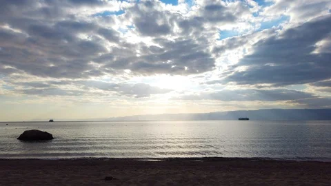 The sun breaks through the clouds. deserted beach. Stock Footage 123600837