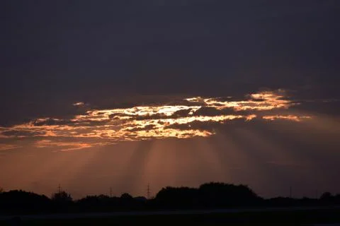 The sun breaks through the clouds in the evening. Stock Photos