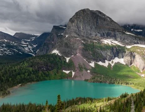 Sun Breaks Through Clouds Over Grinnell Lake 写真素材
