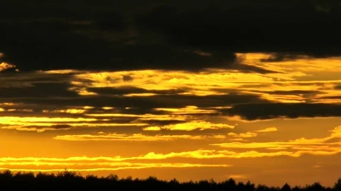 The sun bright lights the earth and hides in storm dense clouds. Time-lapse. Stockbeeldmateriaal 70468342