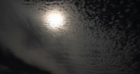 Sun burns through a bank of Cirrocumulus clouds in an afternoon sky. Stock Footage 339515353