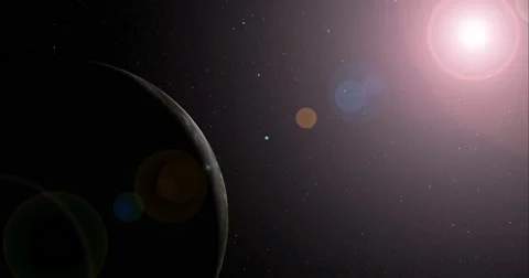 The sun bursts into view over Dione's horizon and illuminates the surface. Stock-Footage 64059421