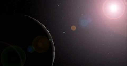 The sun bursts into view over Iapetus' horizon and illuminates the surface. Stock Footage 63799592