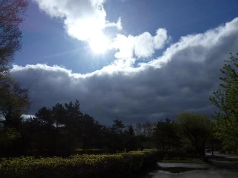 The sun came out from behind the clouds after a rainstorm. Ecology Day. The c Stock Photos