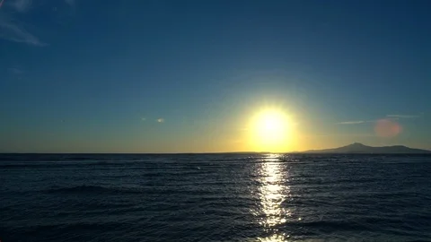 Sun casting a reflection over the ocean at sunset Video stock 100579619