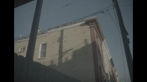 Sun casting shadow on urban street buildings Video stock 285472721