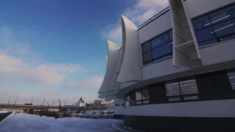 Sun casts glow on rooftop of building while shadows form on wall Video stock 290519295
