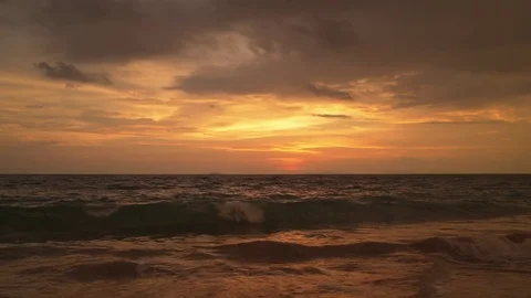 Sun casts vivid colors through out clouds over the Indian ocean Stock Footage 84582790