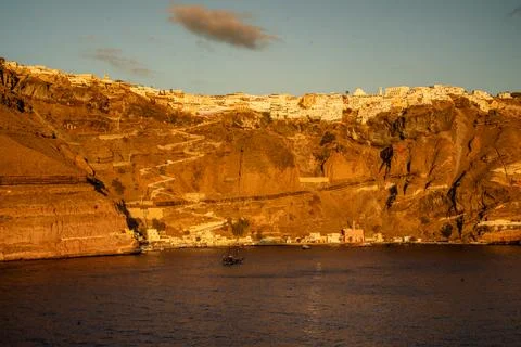 The sun casts a warm glow over the cliffside village Stock Photos