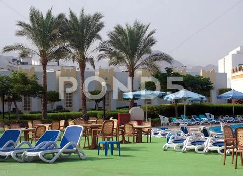 Sun chairs and umbrellas Stock Photos