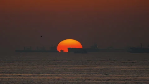Sun Circle and Cargo Ships At Dusk Stock-Footage 240632406
