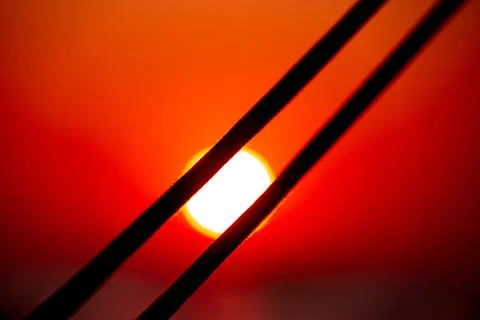 Sun circle under sailing ropes and lifeline on red sunset sky Stock Photos