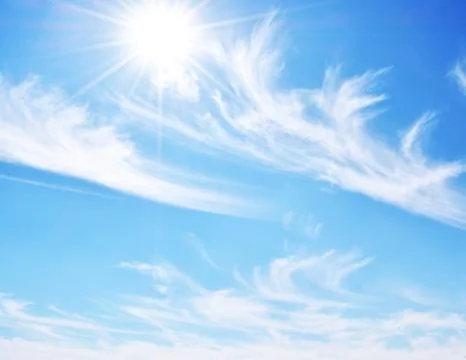 Sun in clear white cloud sky Stock Photos