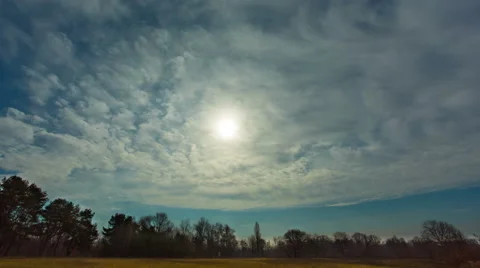 The sun in clouds above forest, time lapse. Bright foggy rays are seen Stock-Footage 48267681