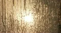The sun, clouds behind the window glass with hoarfrost and runback (time lapse) HD Footage