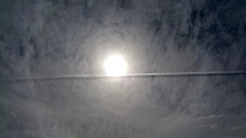 Sun on the cloudy sky inverse track from airplane. Panoramic photo Stock Photos