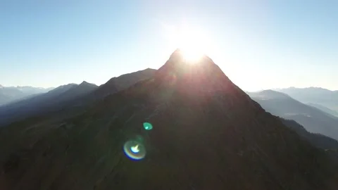 Sun comes up behind mountain Video stock 141388455