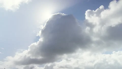 The sun comes out from behind a cloud in good weather, in France Stock Footage 229686248