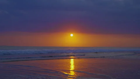 Sun comes out from behind the clouds against background ocean Video stock 277198658