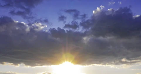 The sun comes out from behind dark clouds at sunset Stock Footage 198548948