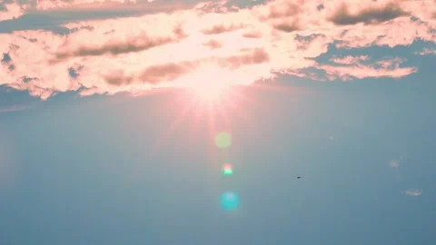 The Sun Comes Out From Under an Orange Pink Cloud in a Blue Sky at Sunset. Sunny Stock Footage 241415942