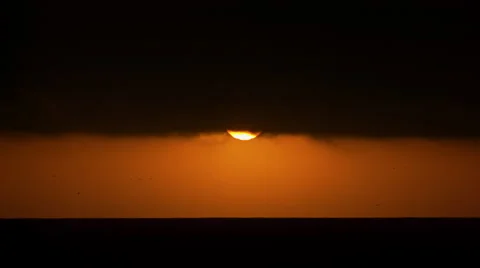 Sun coming out of the cloud before sunset in the ocean Stock Footage 62846504