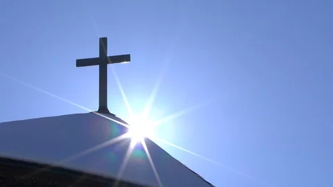 The sun is coming out next to a catholic cross, Timelaps Stock Footage 102488173