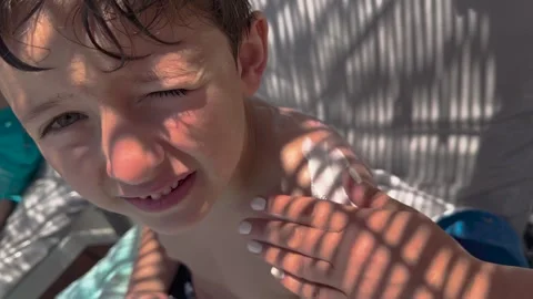 Sun cream concept, Applying sun cream, body milk to children boy in sunny t.. Stock Footage 256244660