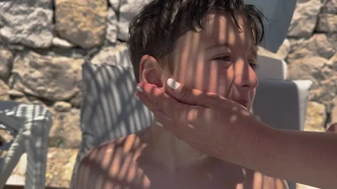 Sun cream concept, Applying sun cream, body milk to children boy in sunny t.. Stock Footage 256244856