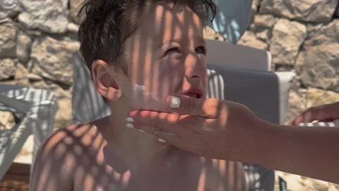 Sun cream concept, Applying sun cream, body milk to children boy in sunny t.. Stock Footage 256244962