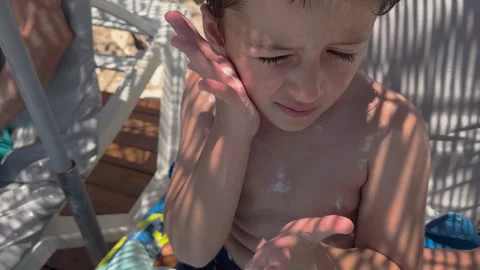 Sun cream concept, Applying sun cream, body milk to children boy in sunny t.. Stock Footage 256245245