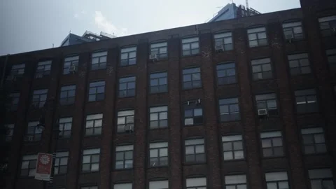 Sun crests over old red brick warehouse in Greenpoint Brooklyn Stock Footage 243811502